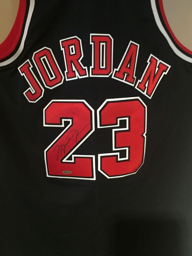 Autographed black Chicago Bulls Michael Jordan number 23 jersey