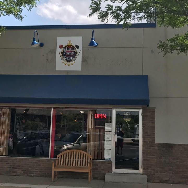 The Absolute Sports Cards storefront with sign, awning and OPEN neon